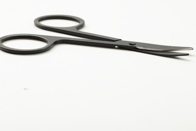Sharp surgical scissors laid out on a clean white surface.