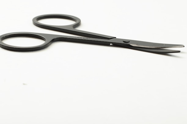 Close-up of finely crafted surgical scissors resting on a clean white surface.