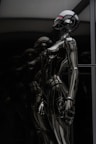 stainless steel robot toy in close up photography