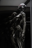 stainless steel robot toy in close up photography