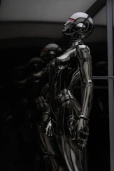 stainless steel robot toy in close up photography