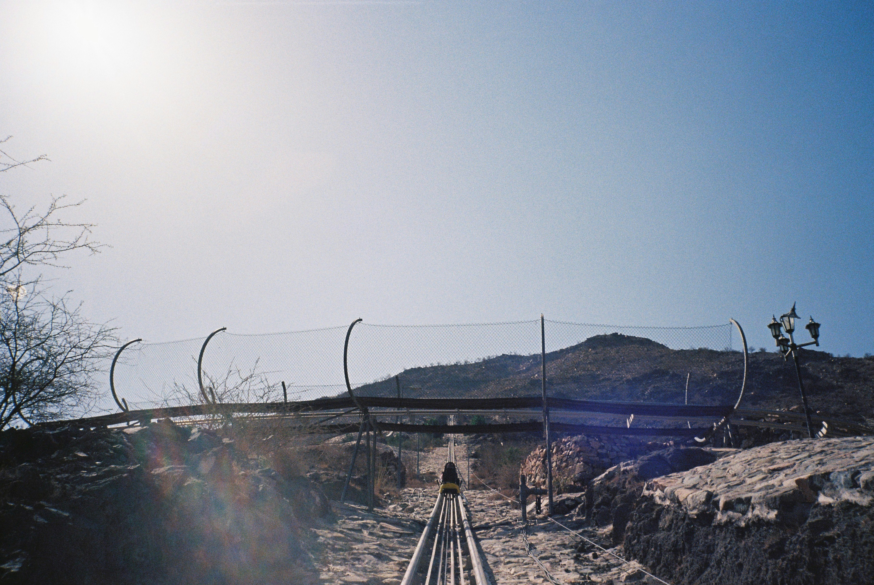 person walking on gray rocky road during daytime