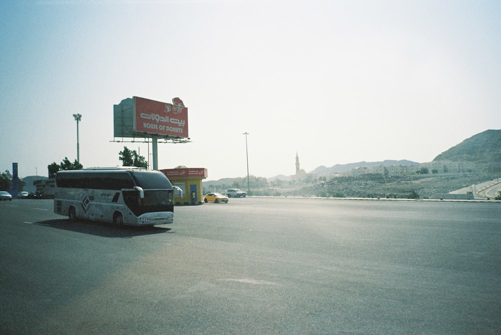 black car parked near red and white signage during daytime