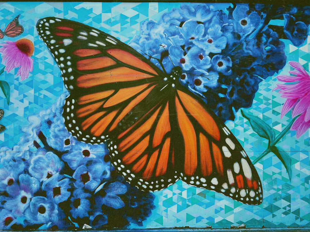 monarch butterfly on blue and white floral textile