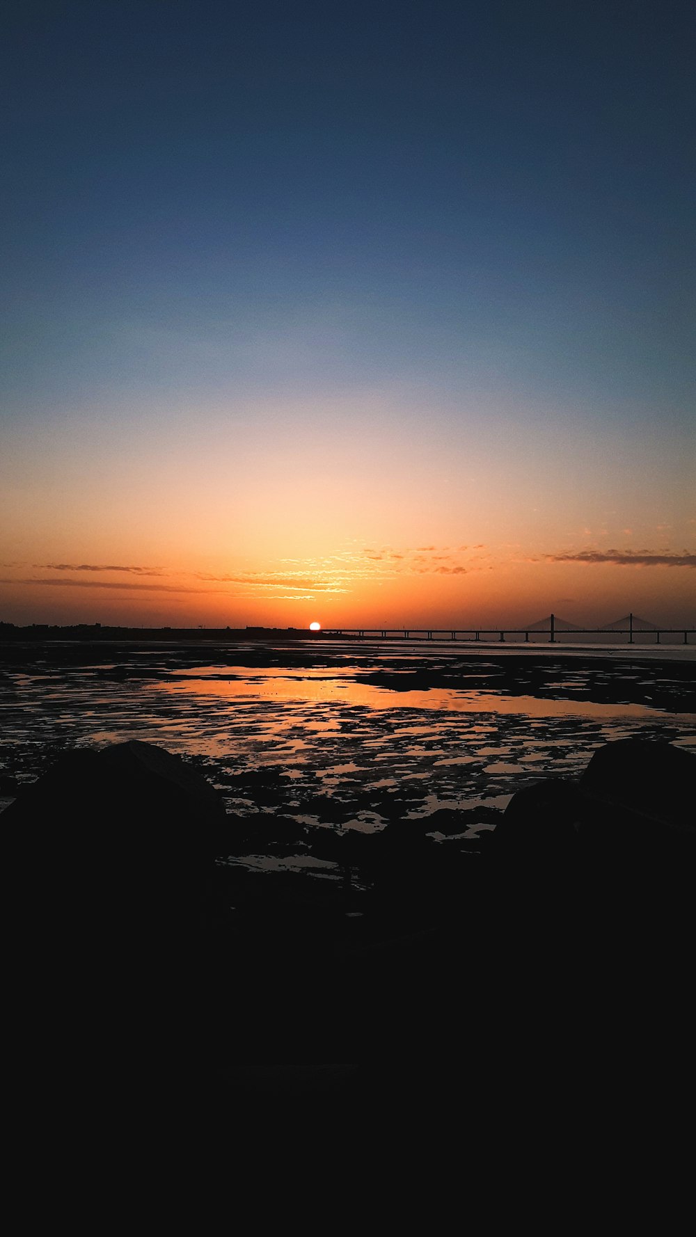 silhouette of bridge during sunset