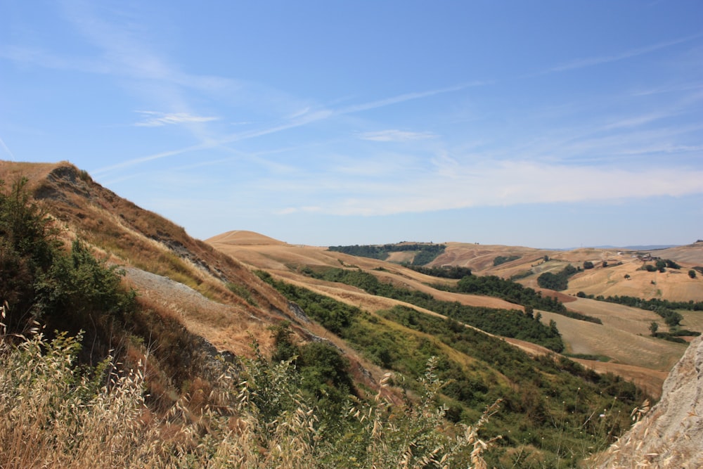 brown and green mountains under blue sky during daytime