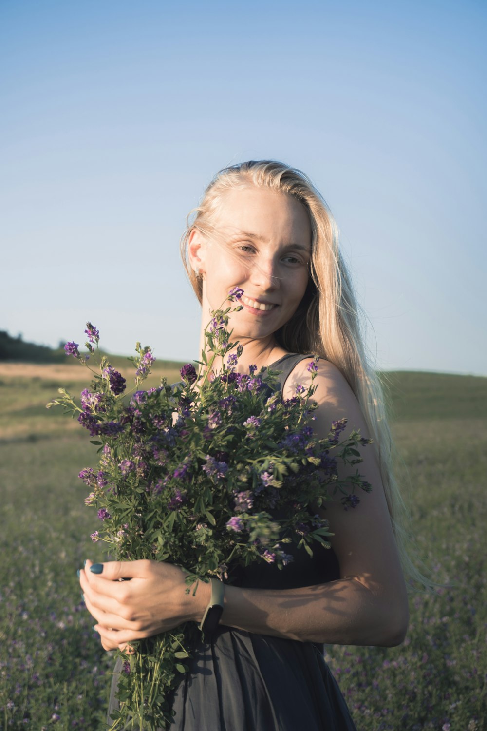 girl holding purple flower bouquet