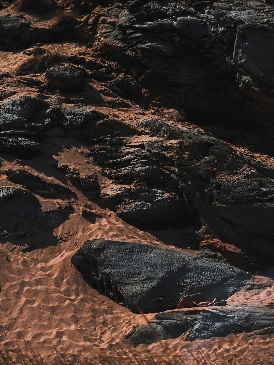 brown rock formation on brown sand during daytime