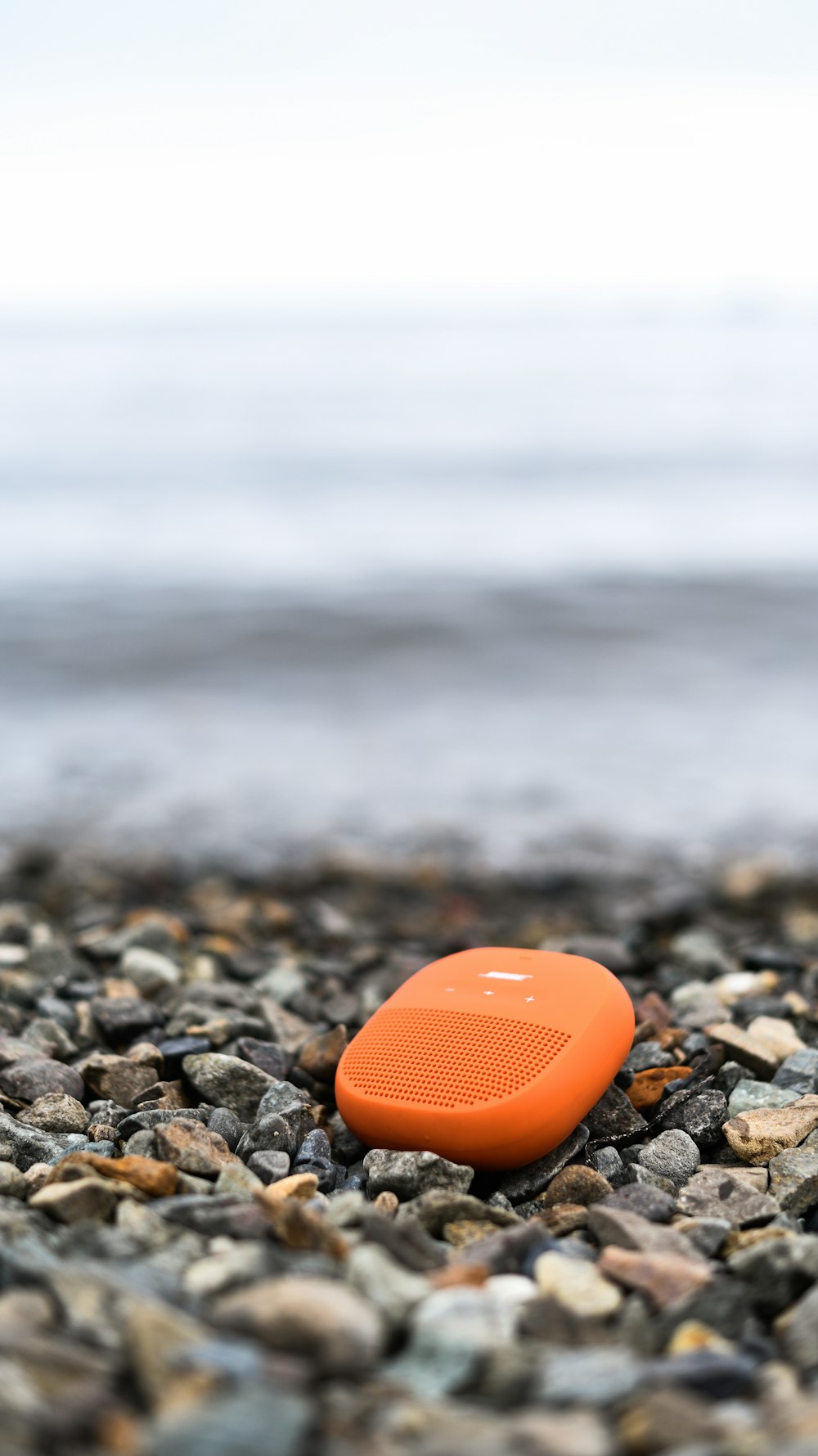 orange heart on rocky shore during daytime
