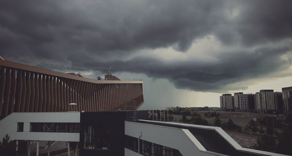 brown and white concrete building under gray clouds