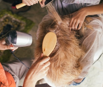 person pouring water on womans hair