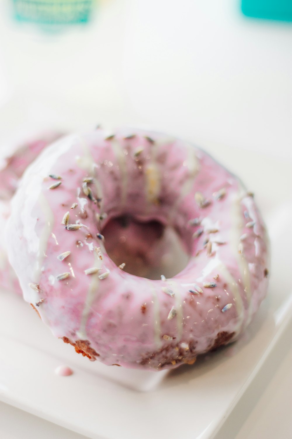 pink doughnut on white ceramic plate