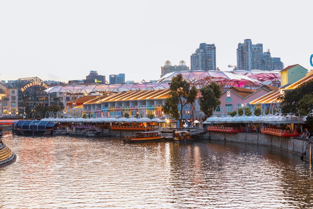 boat on dock near buildings during daytime