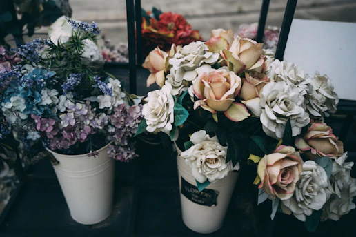 pink and white roses in white ceramic vase