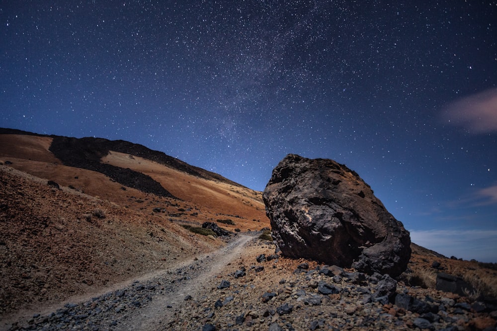 brown mountain under blue sky during night time