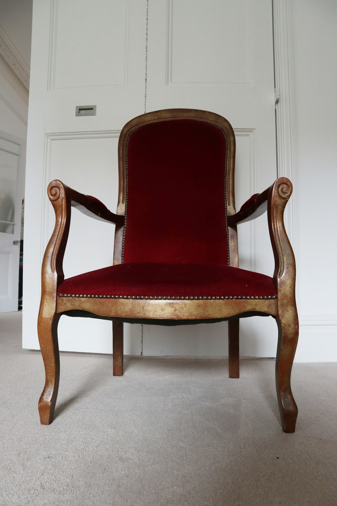 brown wooden framed red padded armchair