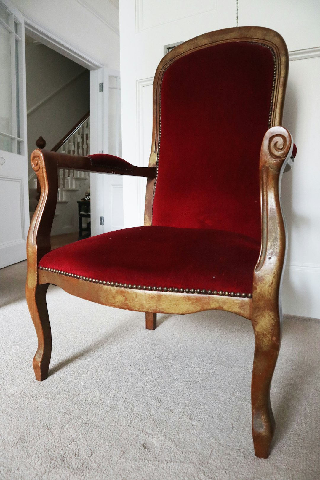 red padded brown wooden armchair