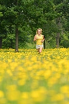 A person joyfully jogging outdoors at sunrise, surrounded by nature.