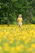 A joyful middle-aged woman enjoying a morning run in a lush park.