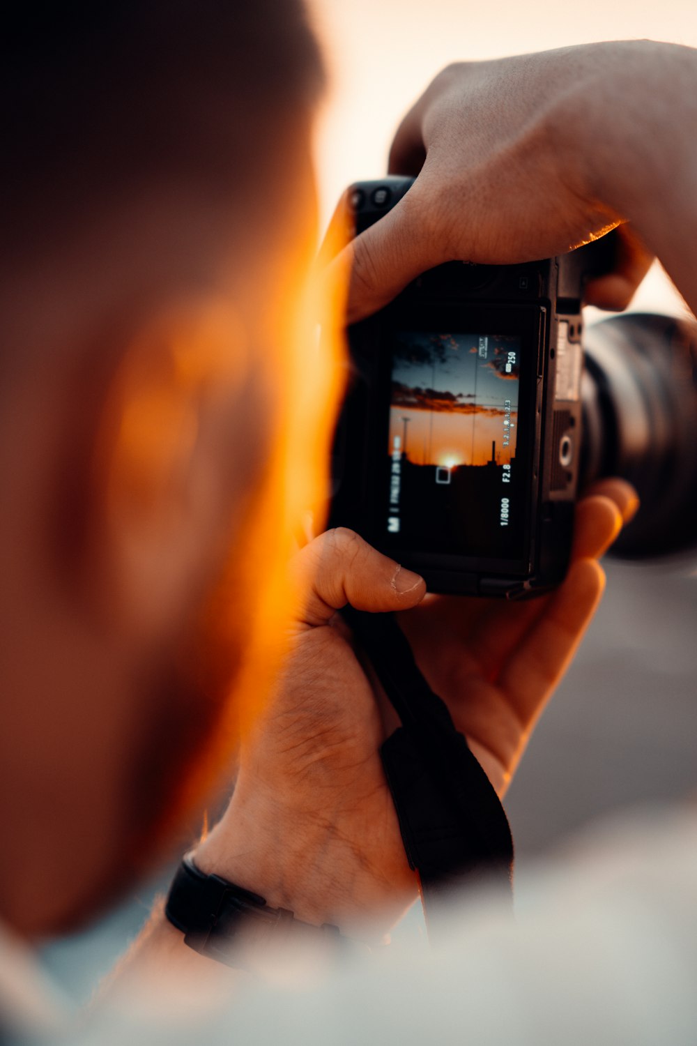 person holding black dslr camera