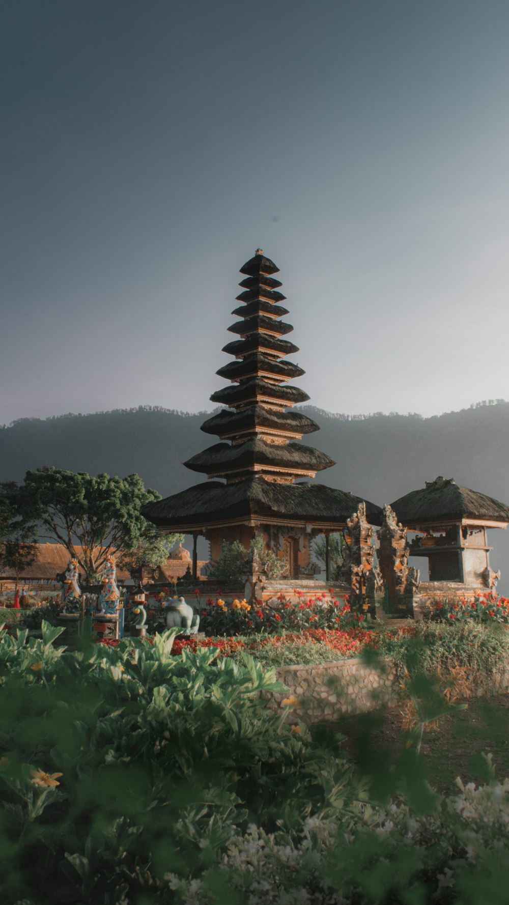 brown and black pagoda surrounded by green plants