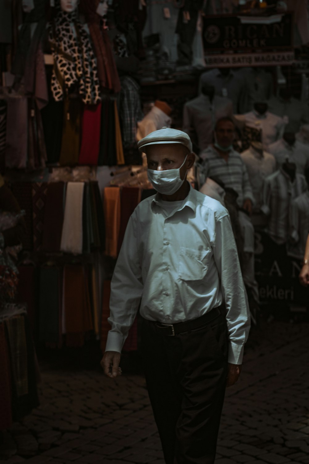 man in white dress shirt and black pants wearing white helmet