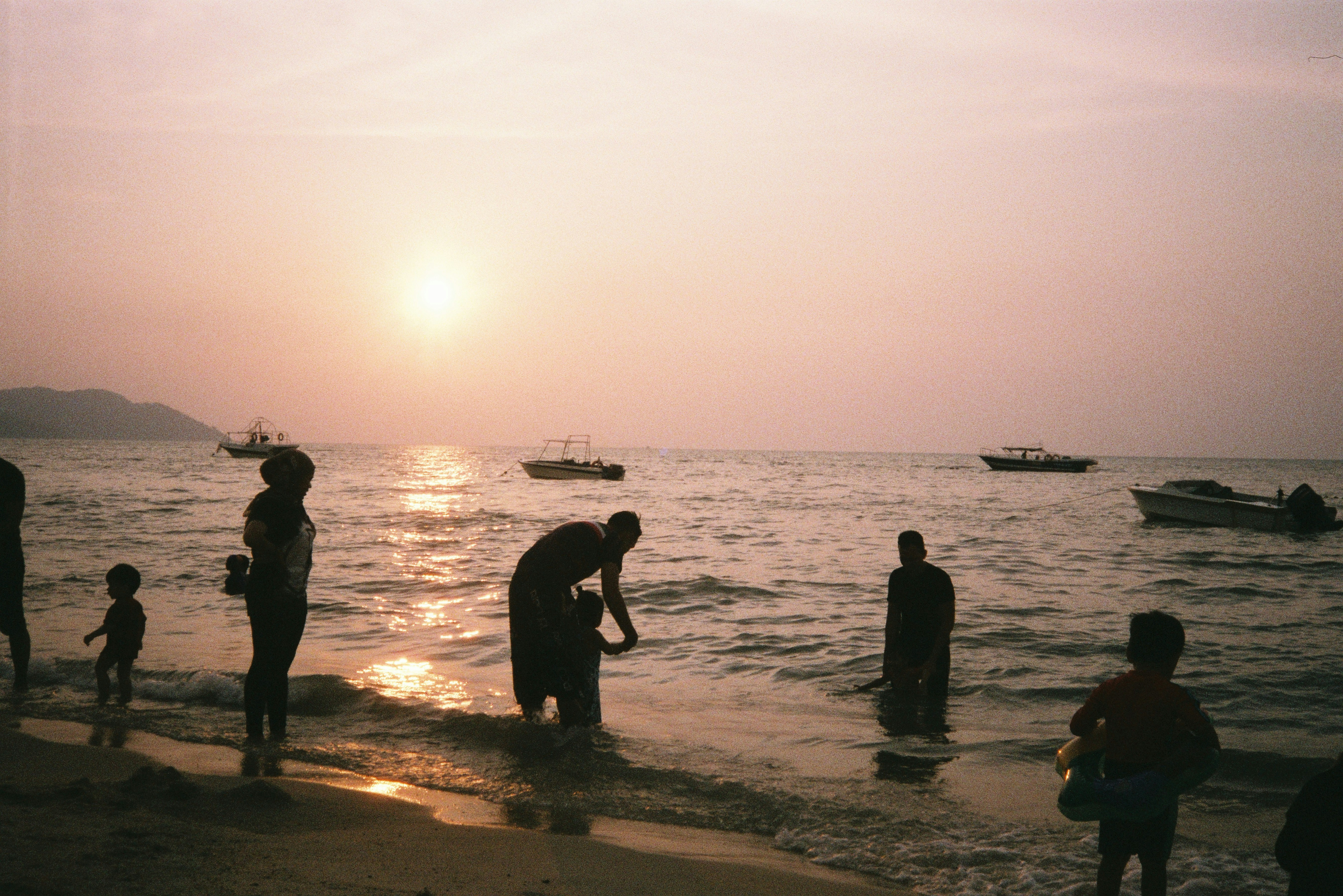 silhouette of people on beach during sunset