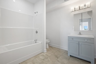 white ceramic bathtub near white wooden door
