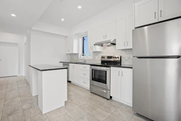 A modern kitchen featuring sleek countertops, fresh cabinetry, and soft under-cabinet lighting.