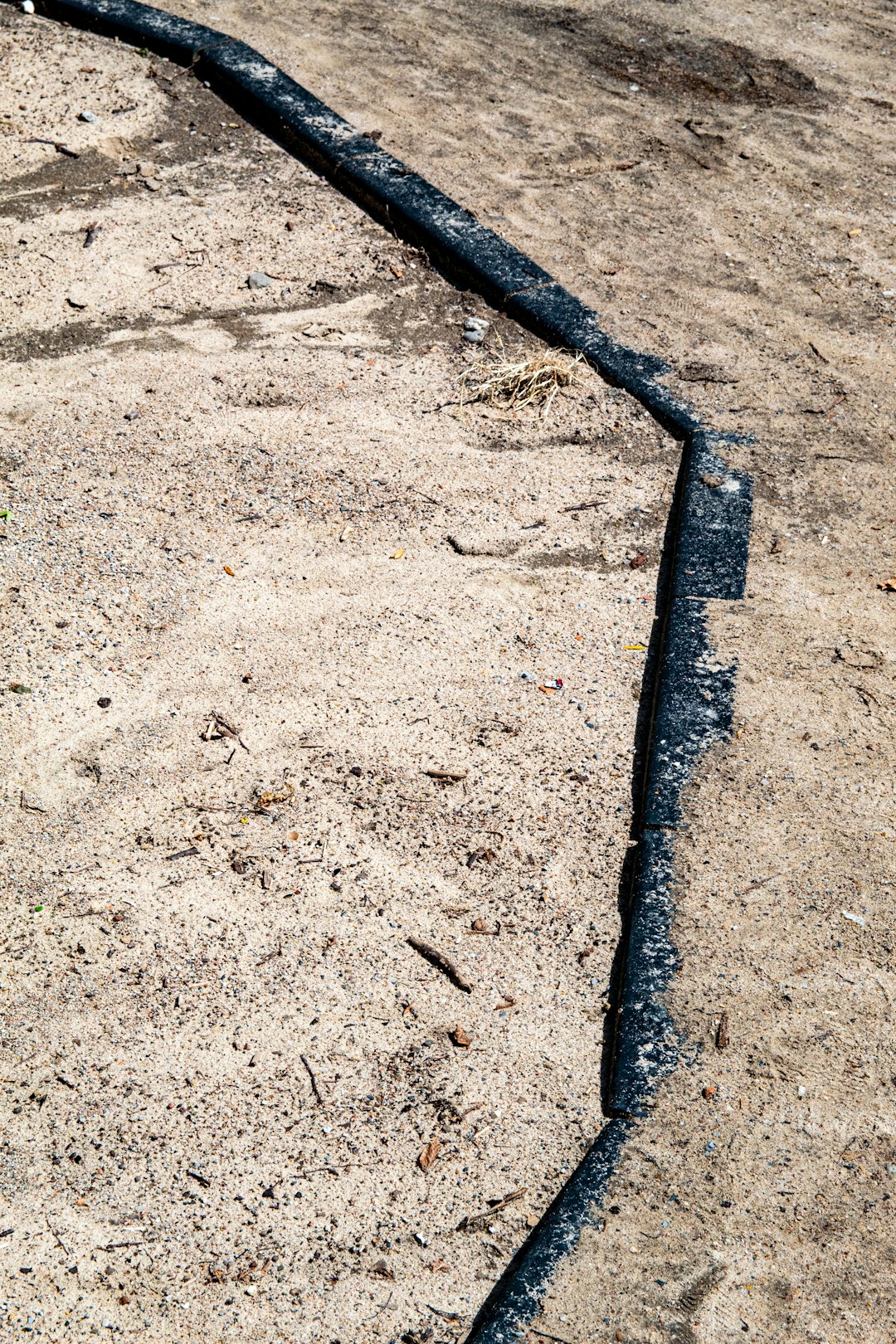 black metal bar on brown sand