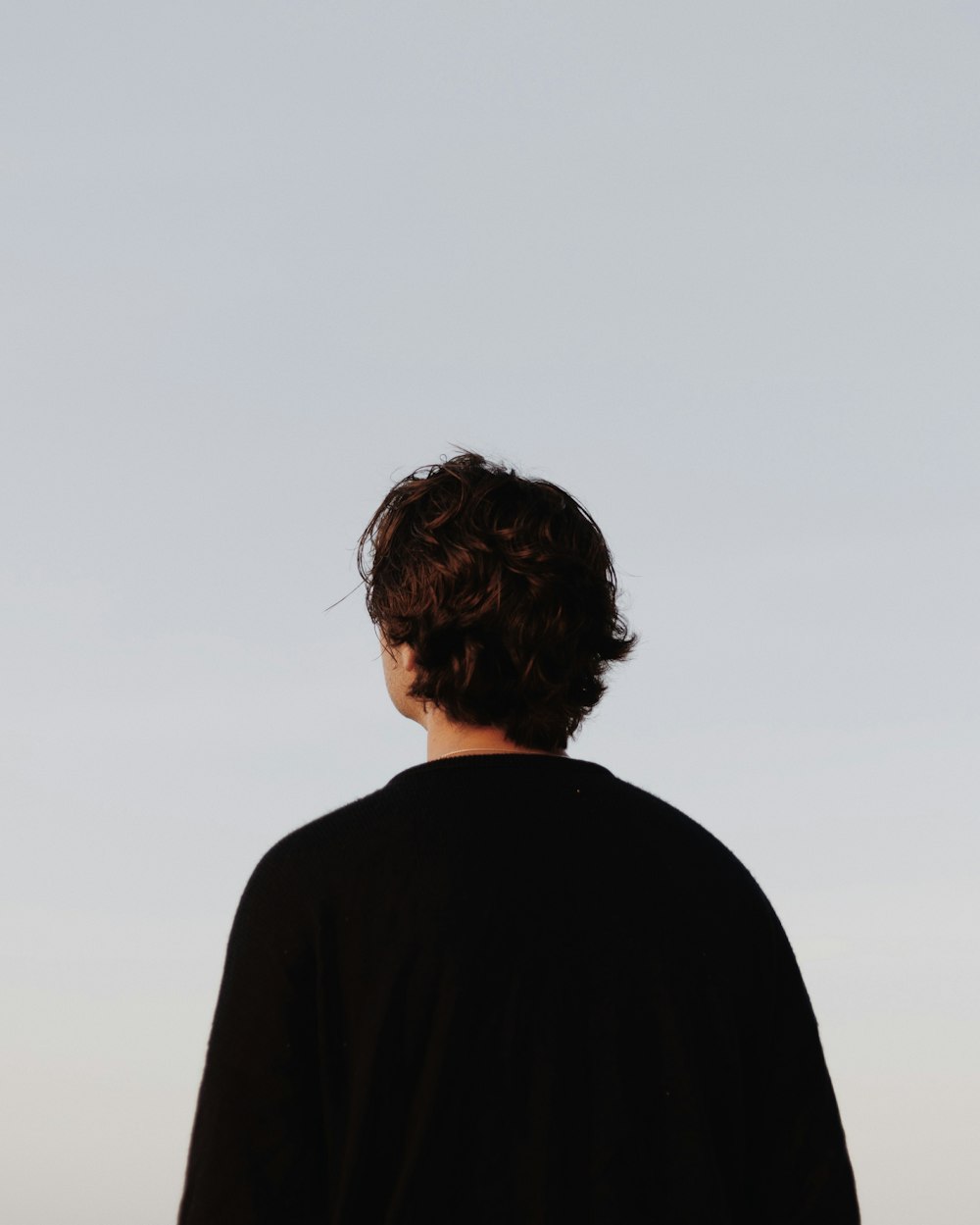 man in black shirt standing during daytime