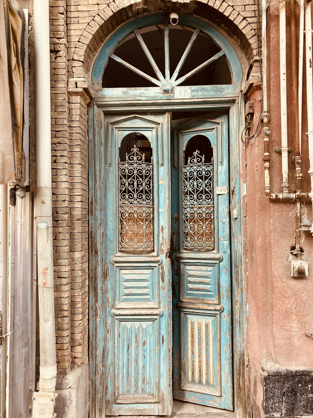 blue wooden door on brown concrete building