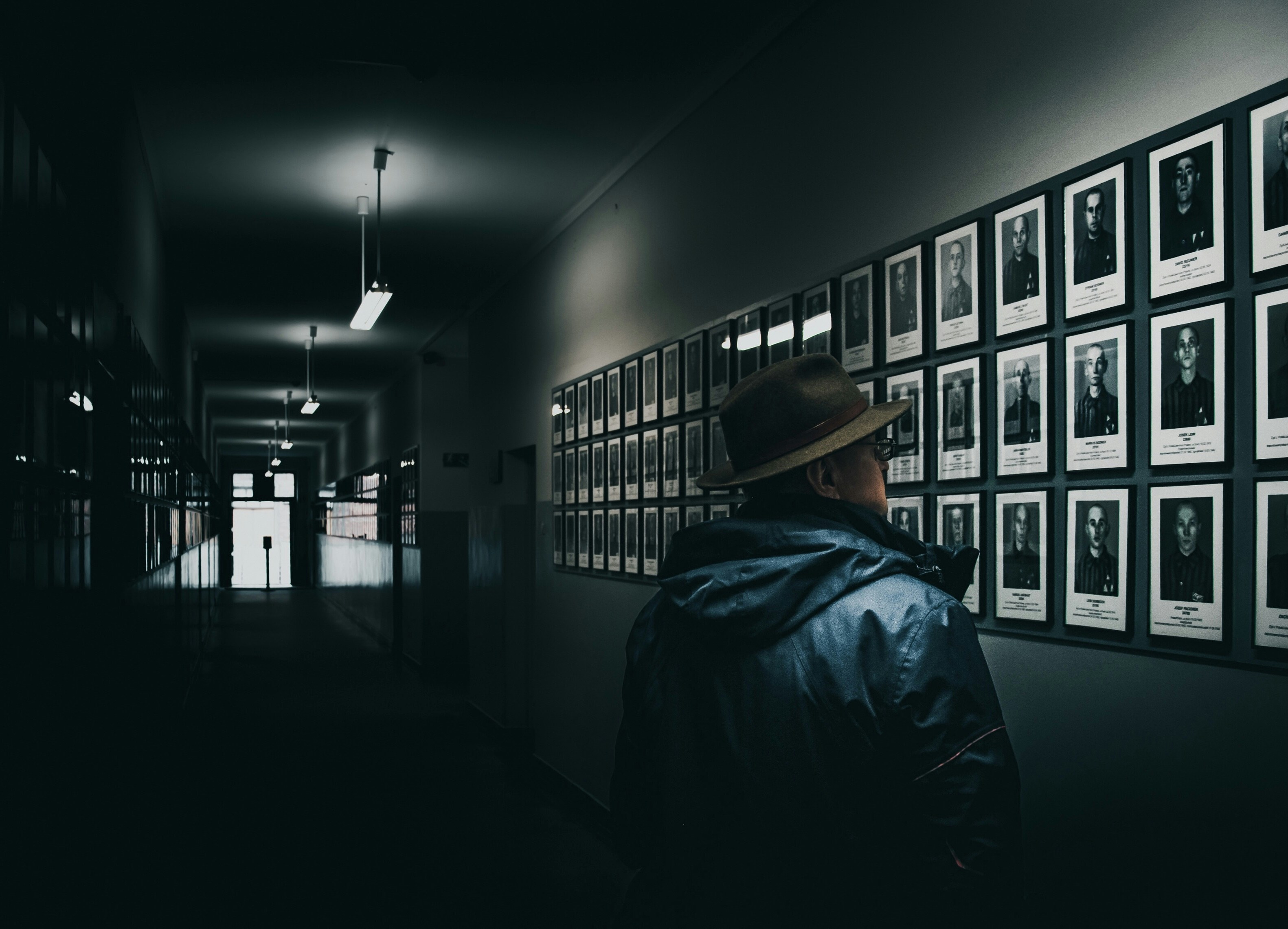 The shot from the Oswiecim museum. The long doorway with thousands of photos of the victims. So cold context in the meta image - historical photos in the historical photo, background in the background, story behind the story.