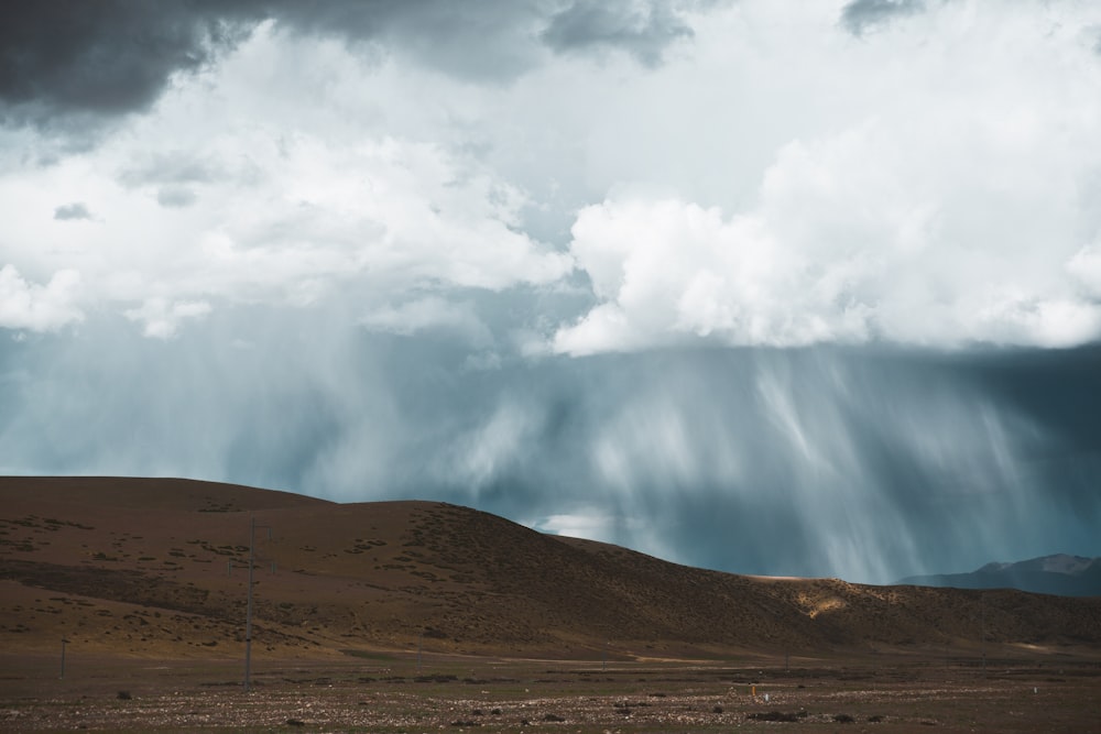 white clouds over brown field