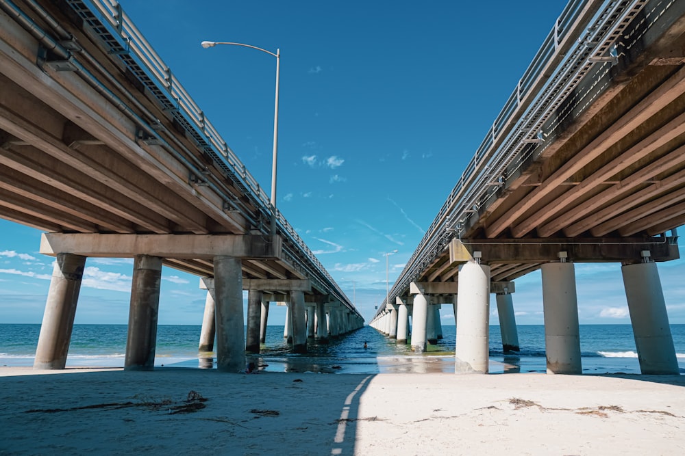 brown wooden bridge over the sea during daytime