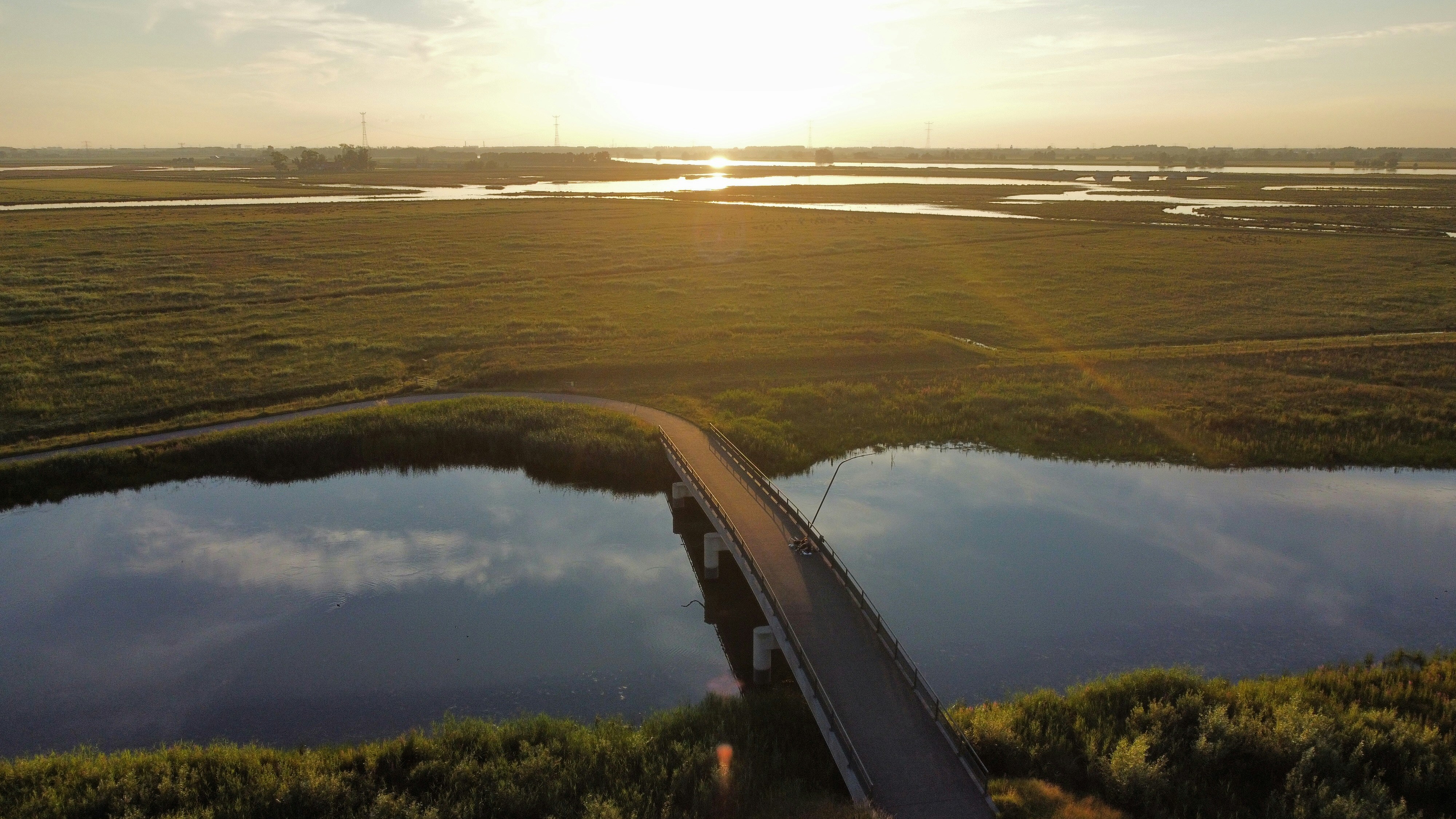 green grass field near body of water during daytime
