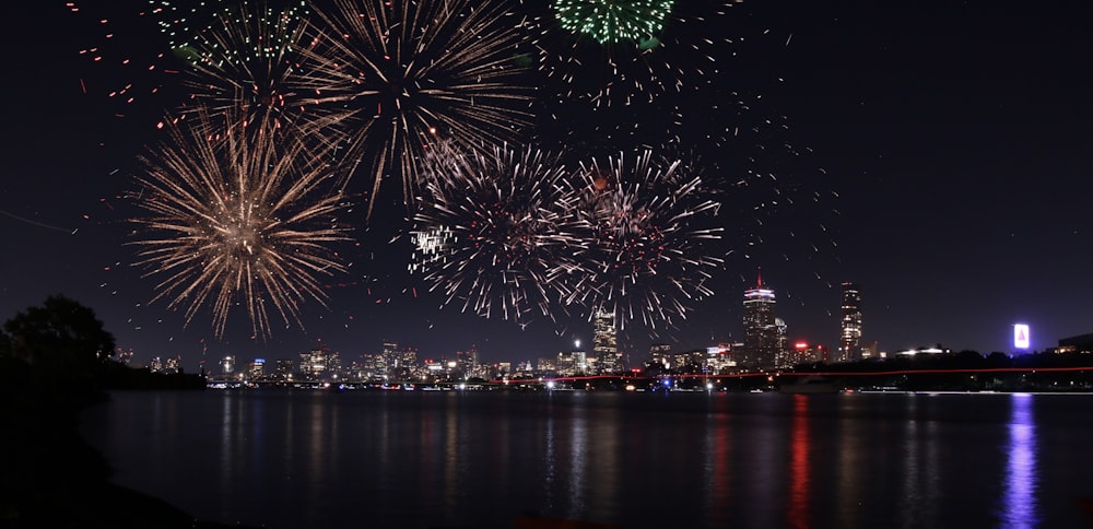 fireworks display over city skyline during night time