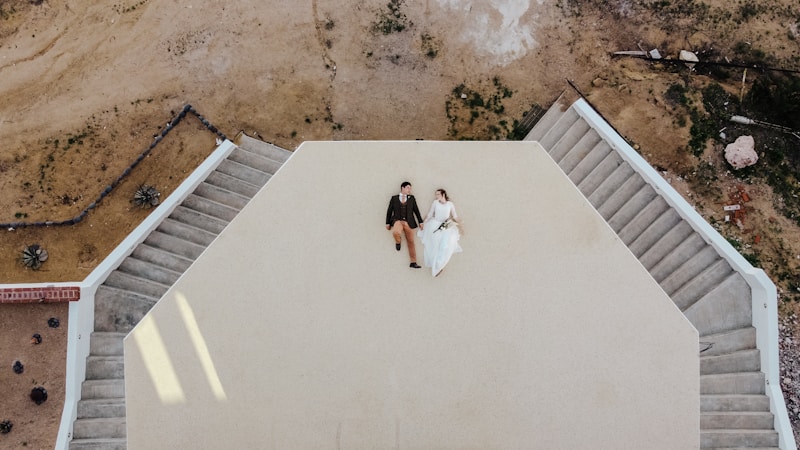 man and woman standing on brown soil during daytime