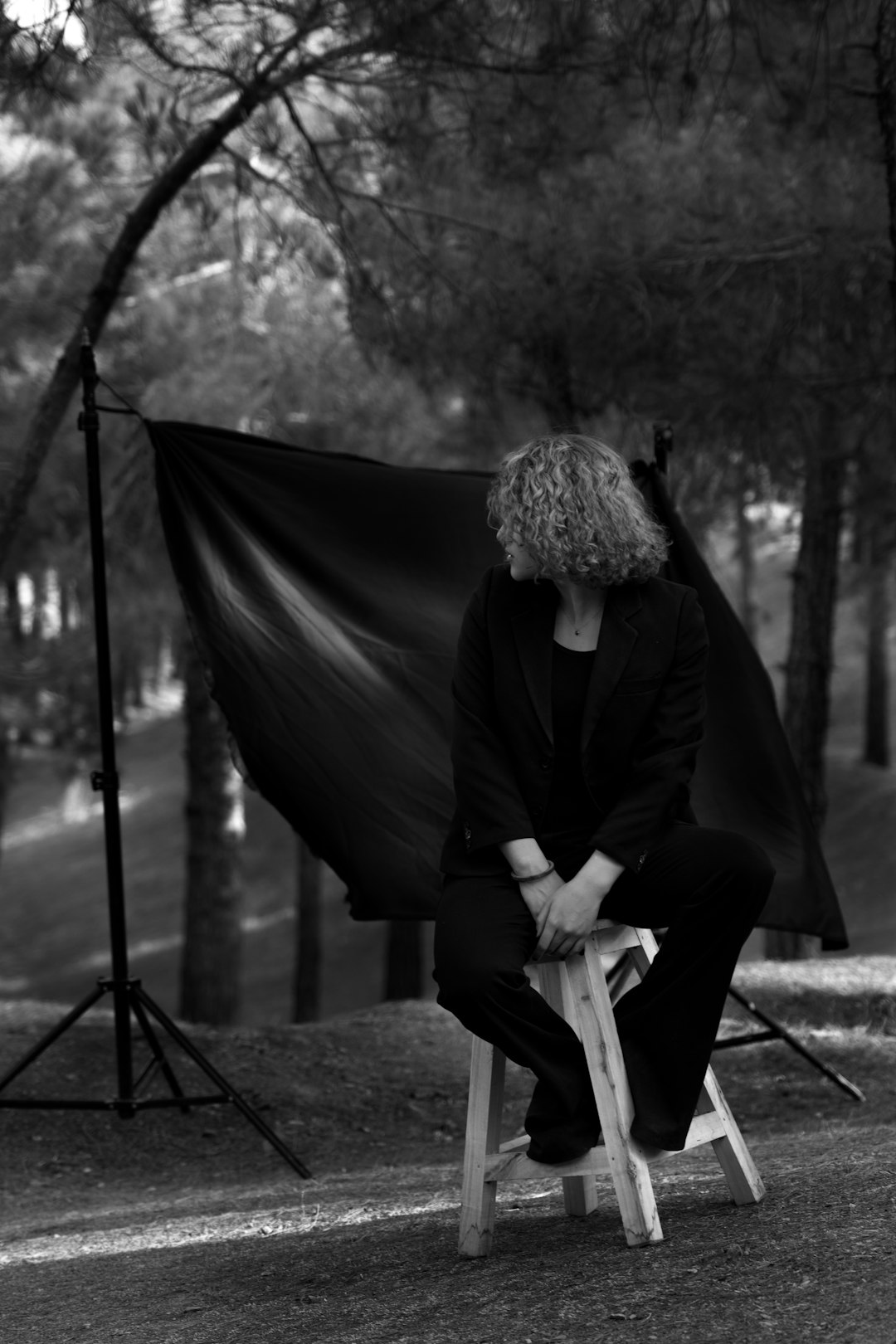 man in black suit standing near black tent