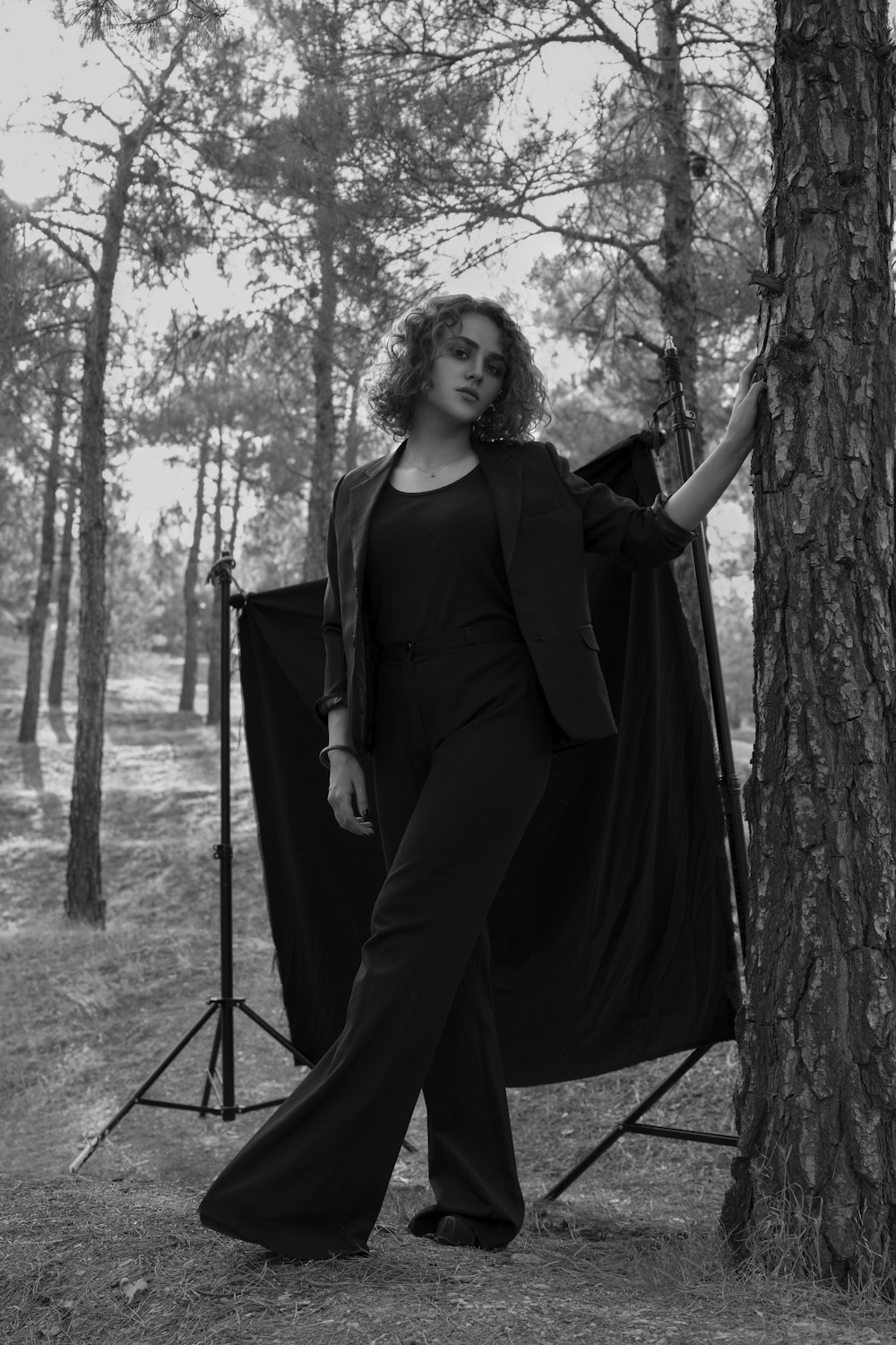 woman in black long sleeve dress standing near tree