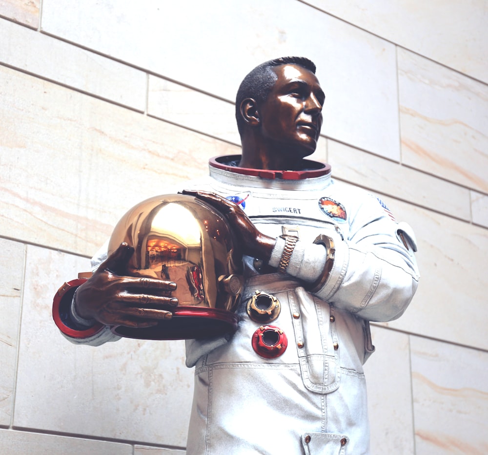 Homme en costume de Power Ranger blanc et rouge tenant un ballon de football marron