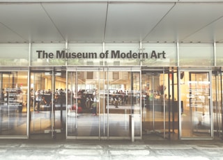 a museum of modern art with people walking in it