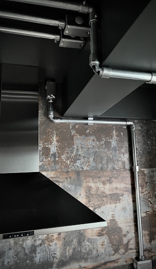 Close-up of a modern kitchen pipe hood with an anti-odor filter system installed.