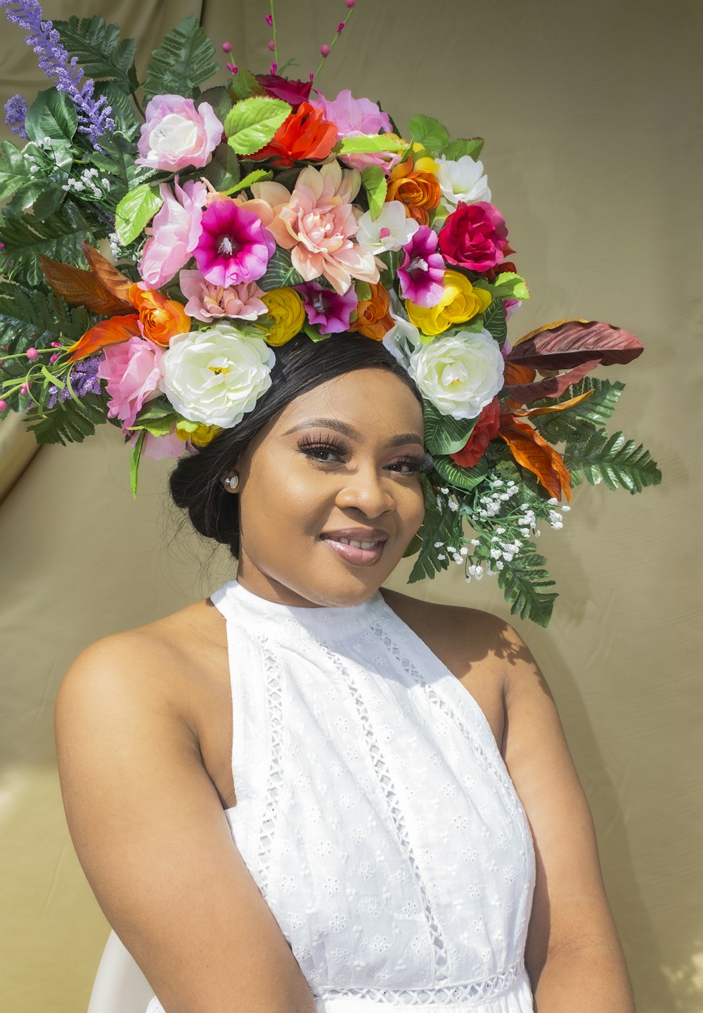 woman in white floral sleeveless dress with flower crown