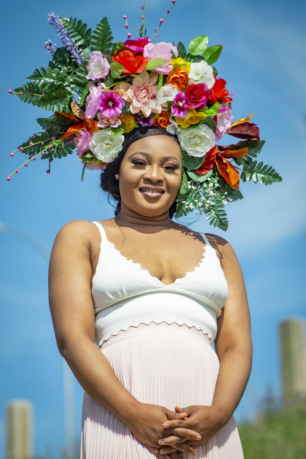 woman in white spaghetti strap dress with flower crown