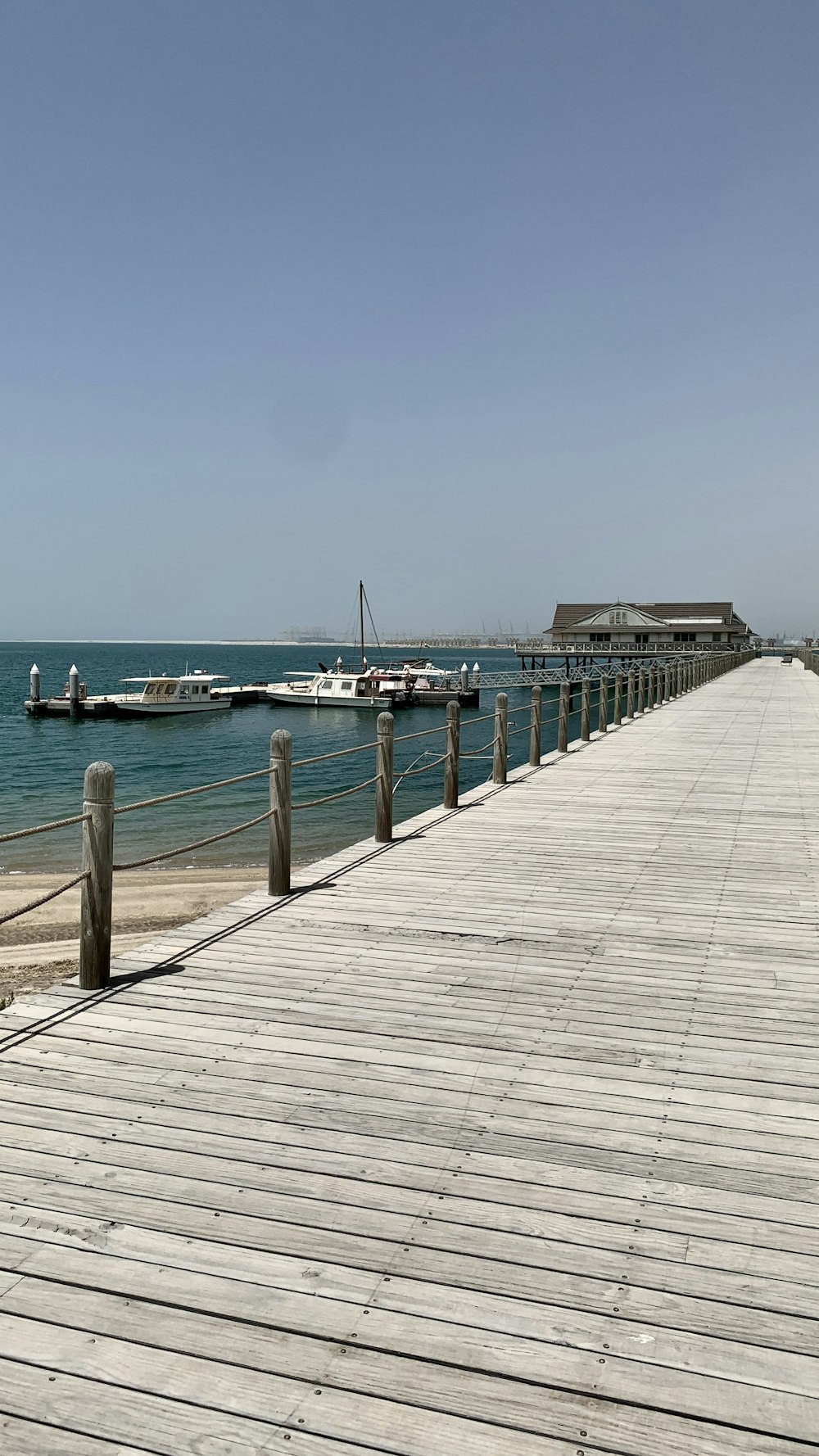 white and blue boat on sea dock during daytime