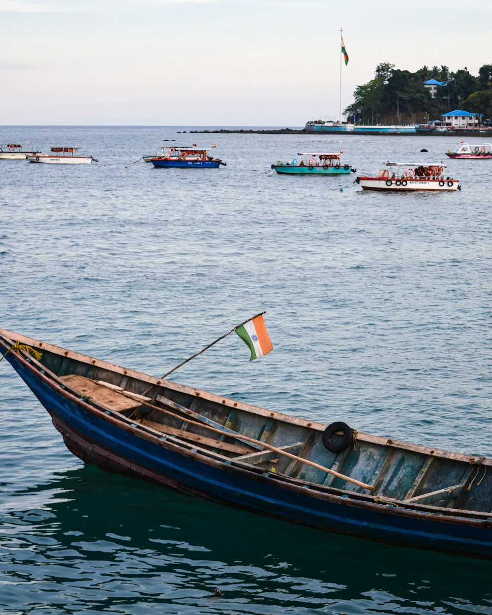 brown and blue boat on sea during daytime