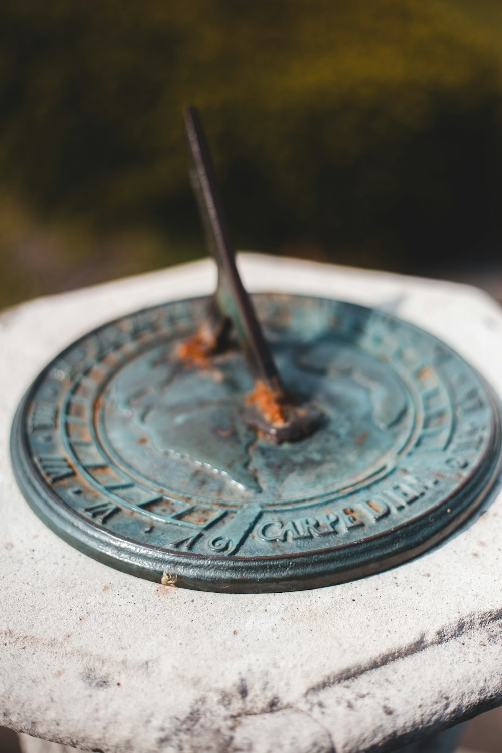 gray metal round ornament on gray concrete surface