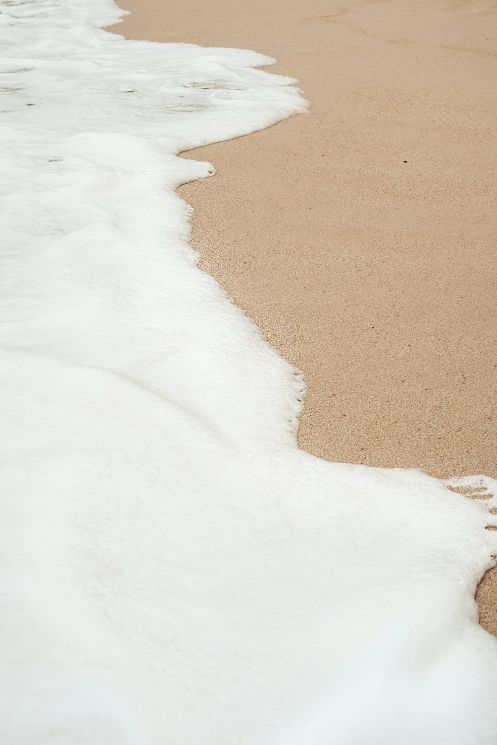 white snow on brown sand