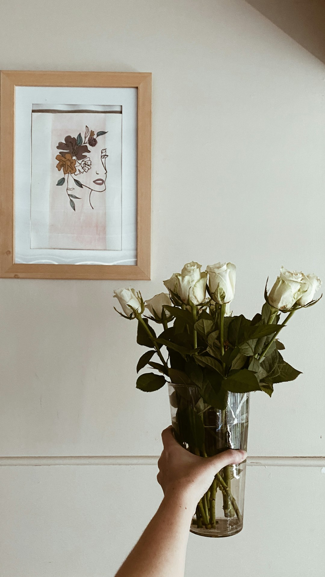 white roses in clear glass vase